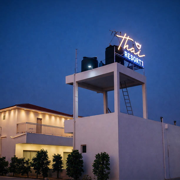 Resort building exterior view at night with lights