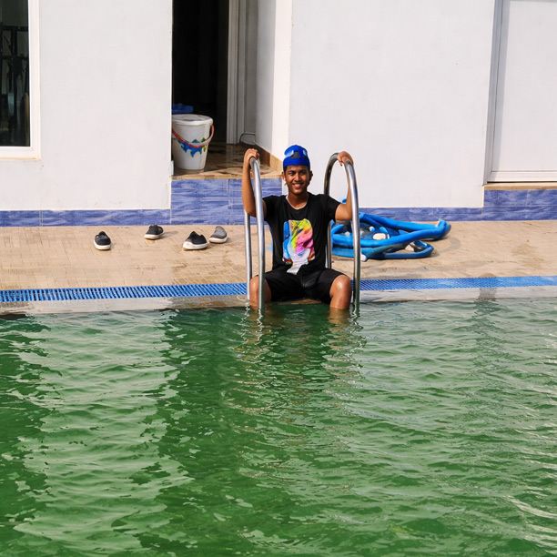 Guest enjoying swimming pool at hotel