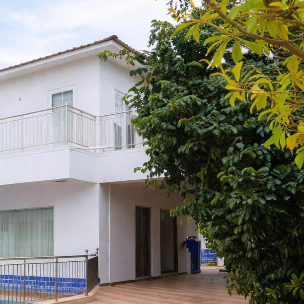 Hotel exterior building with garden and balcony view