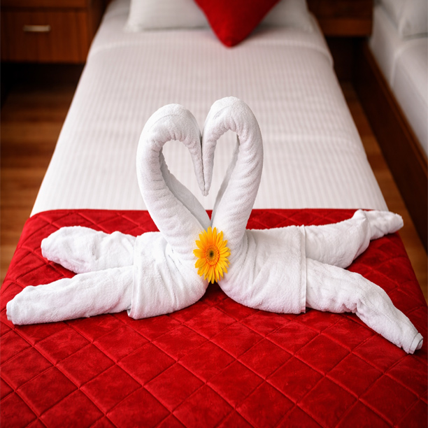 Luxury hotel bed with towel swan decoration